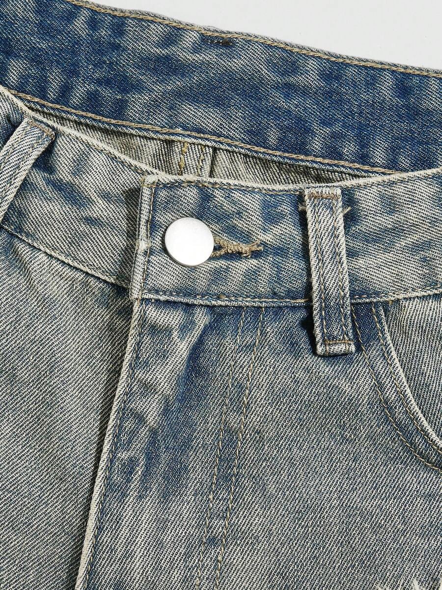 Front view of women's ripped denim shorts featuring raw hem, zipper fly, and pockets