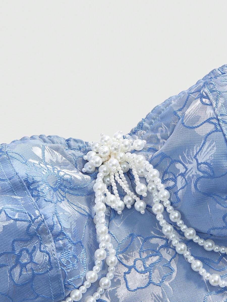 Women's apricot strapless vintage palace style blouse featuring an asymmetrical ruffle hem, backless design, and pearl brooch detail.