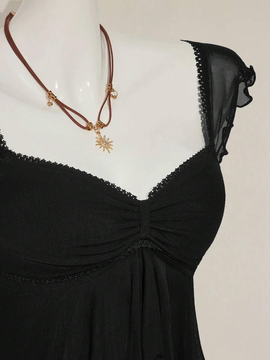 Black slim fit women's ruched front camisole tank top featuring contrast mesh inserts, square neckline, and an asymmetrical crop hem.