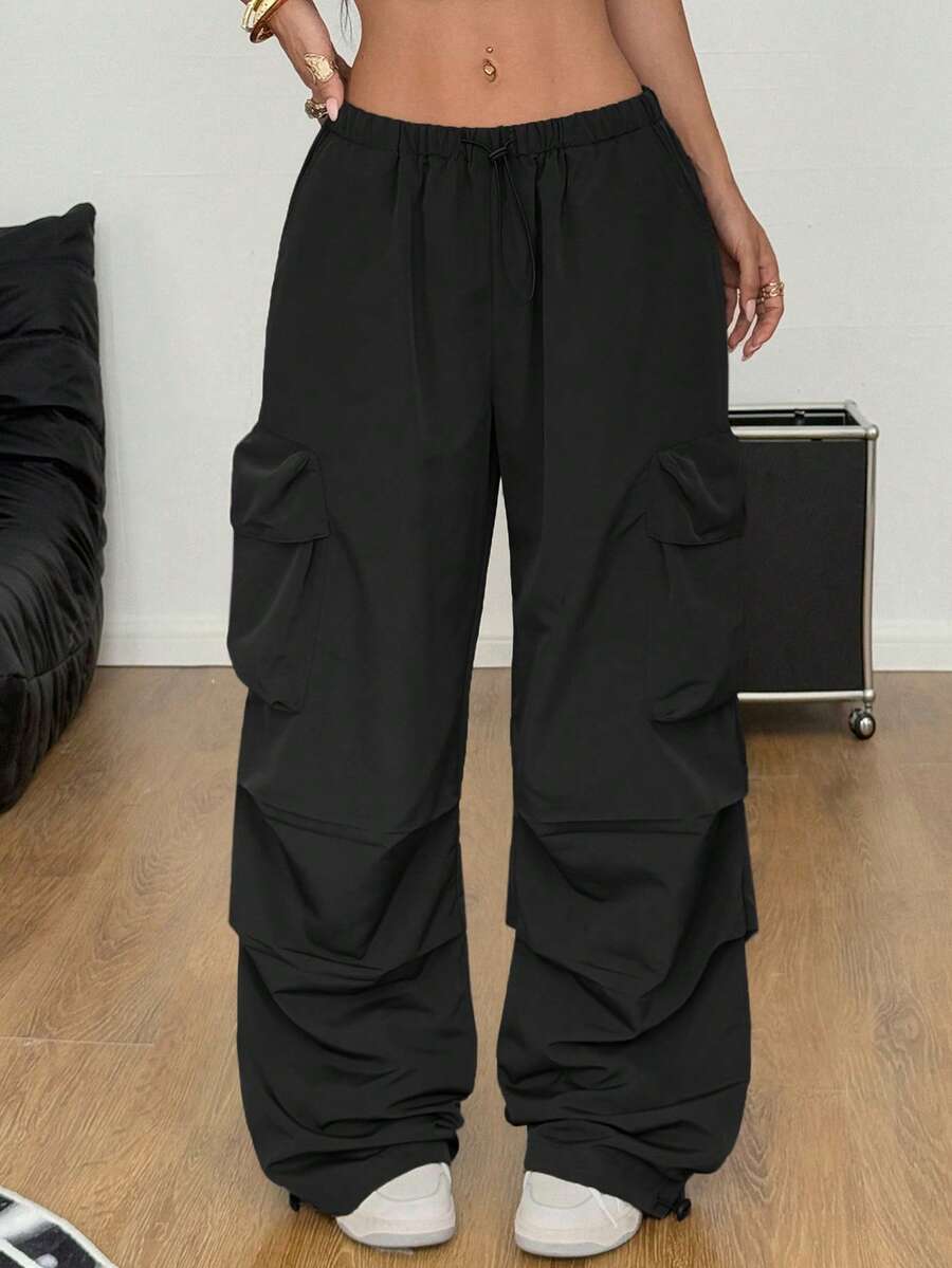 Women's loose fit parachute cargo pants featuring a drawstring waist and functional pockets in a casual streetwear style