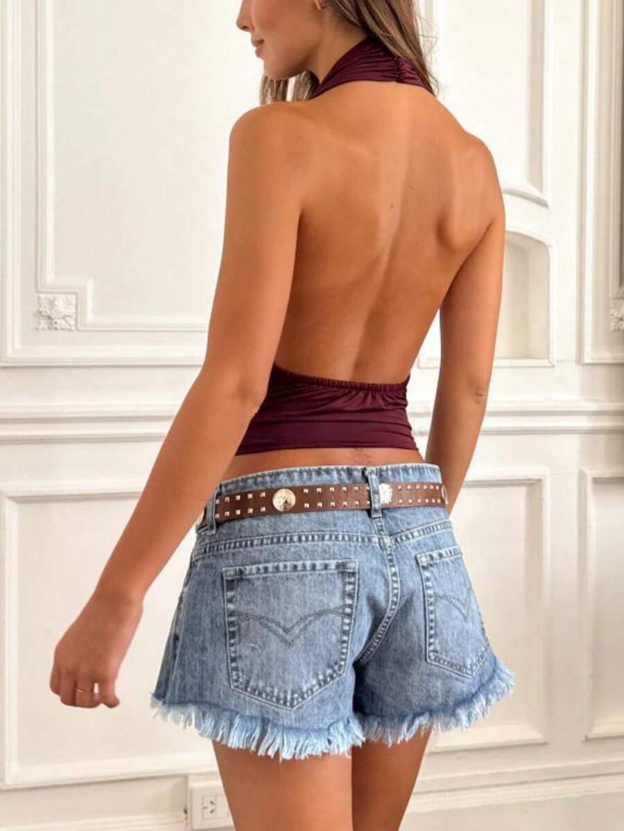 Women's backless halter crop top featuring a draped cowl front, knot detail, and slim fit design.
