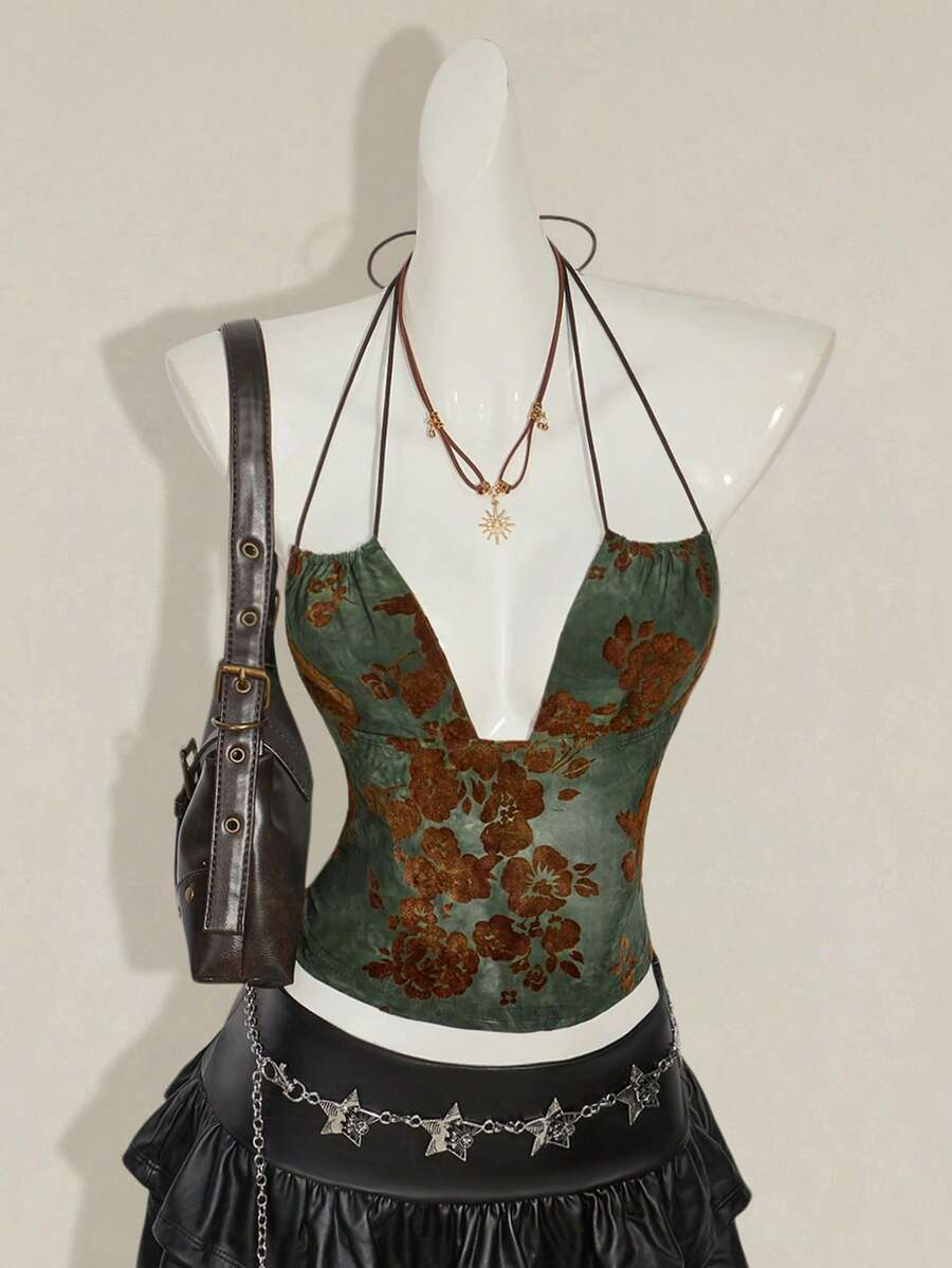 Women's green flocked jacquard halter tank top with plant pattern, criss-cross straps, deep V-back, knot detail, backless cut, and asymmetrical micro crop hem.