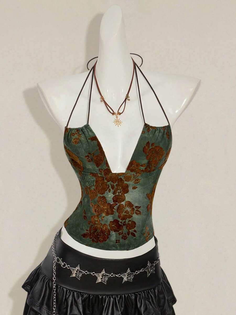 Women's green flocked jacquard halter tank top with plant pattern, criss-cross straps, deep V-back, knot detail, backless cut, and asymmetrical micro crop hem.