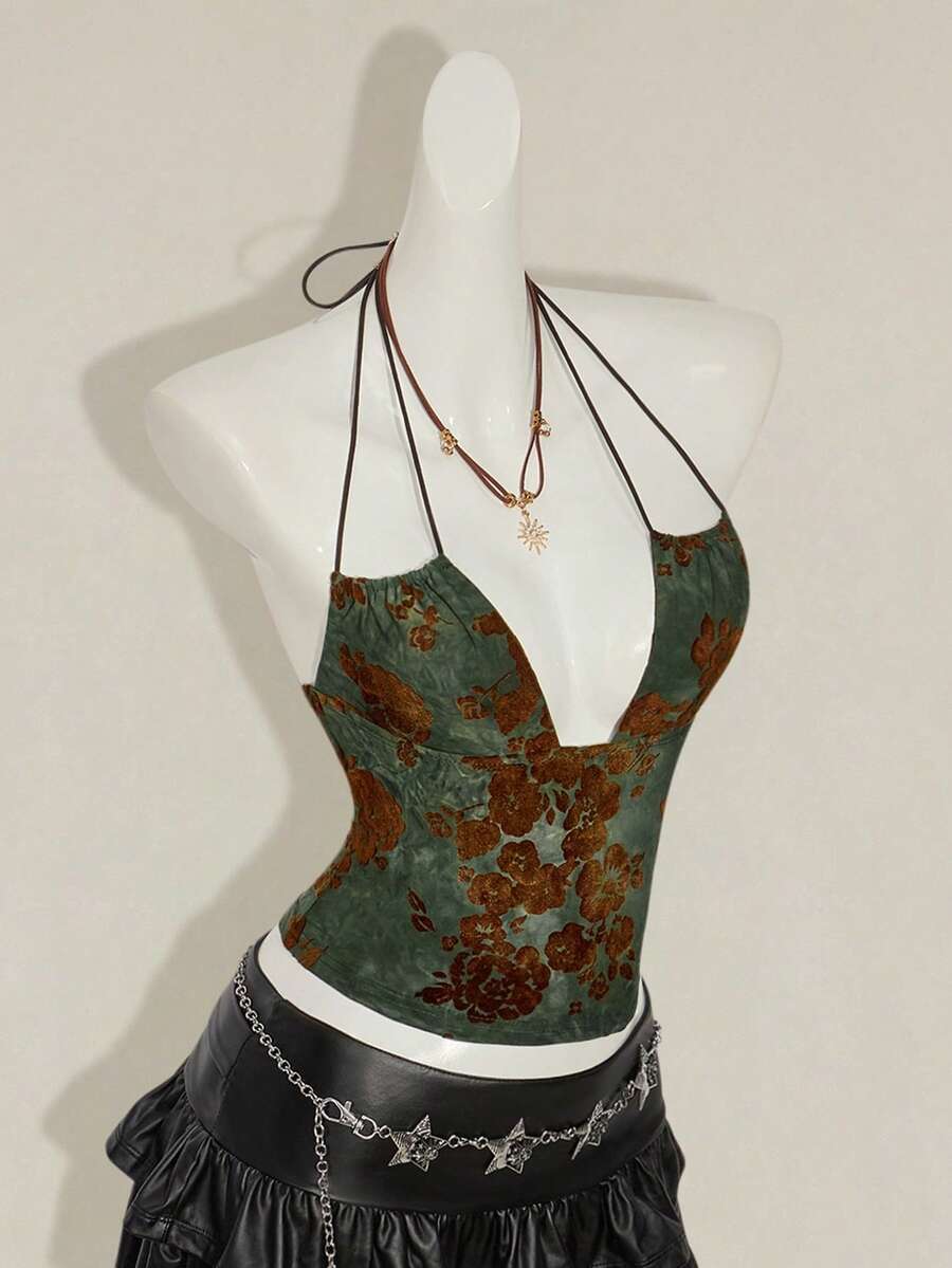 Women's green flocked jacquard halter tank top with plant pattern, criss-cross straps, deep V-back, knot detail, backless cut, and asymmetrical micro crop hem.