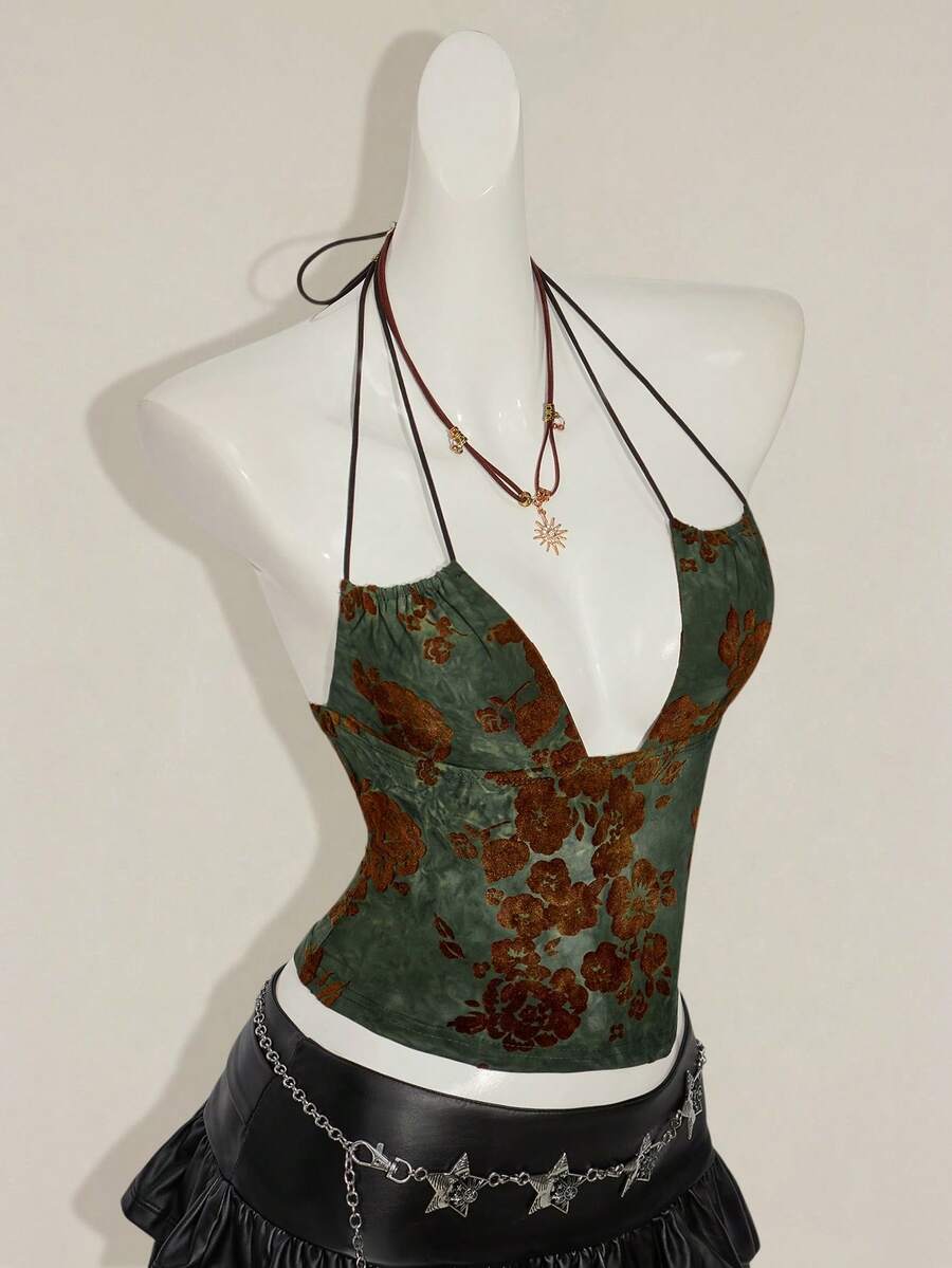 Women's green flocked jacquard halter tank top with plant pattern, criss-cross straps, deep V-back, knot detail, backless cut, and asymmetrical micro crop hem.