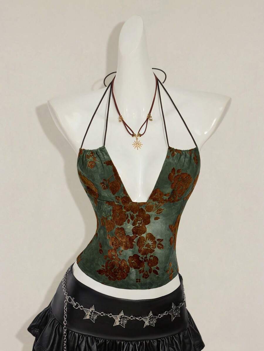 Women's green flocked jacquard halter tank top with plant pattern, criss-cross straps, deep V-back, knot detail, backless cut, and asymmetrical micro crop hem.