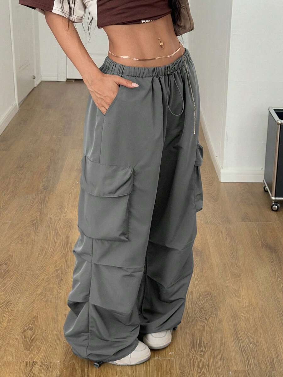 Women's loose fit parachute cargo pants featuring a drawstring waist and functional pockets in a casual streetwear style