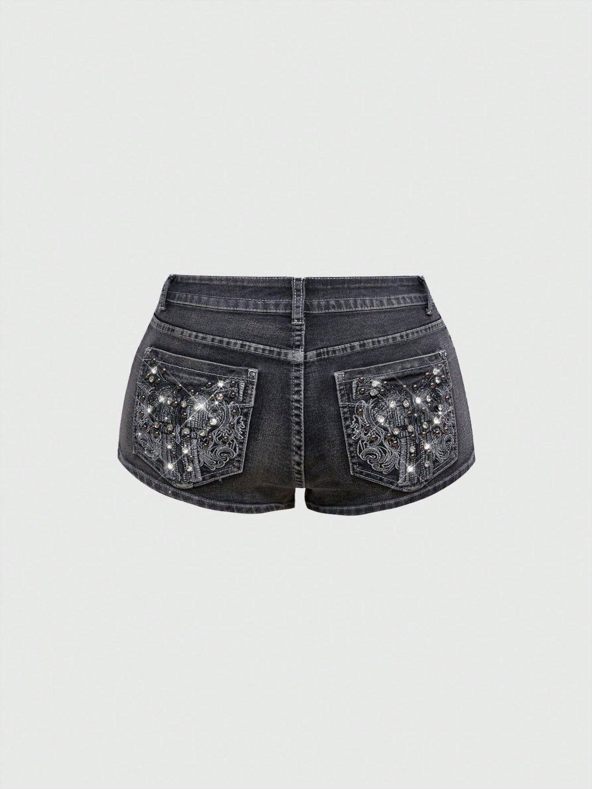 Women's ultra low waist skort with mini shorts length, zipper fly, pockets, pistol embroidery, and rhinestone details