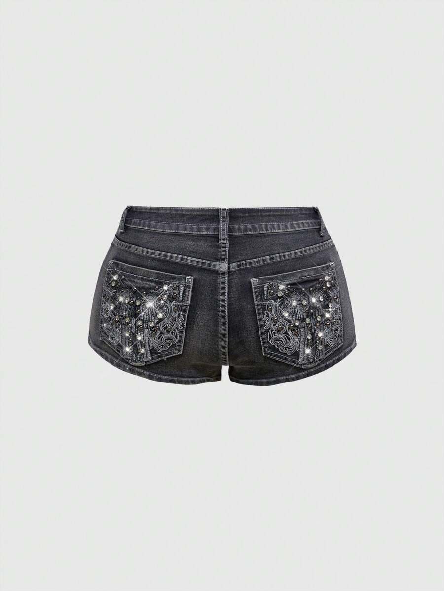 Women's ultra low waist skort with mini shorts length, zipper fly, pockets, pistol embroidery, and rhinestone details