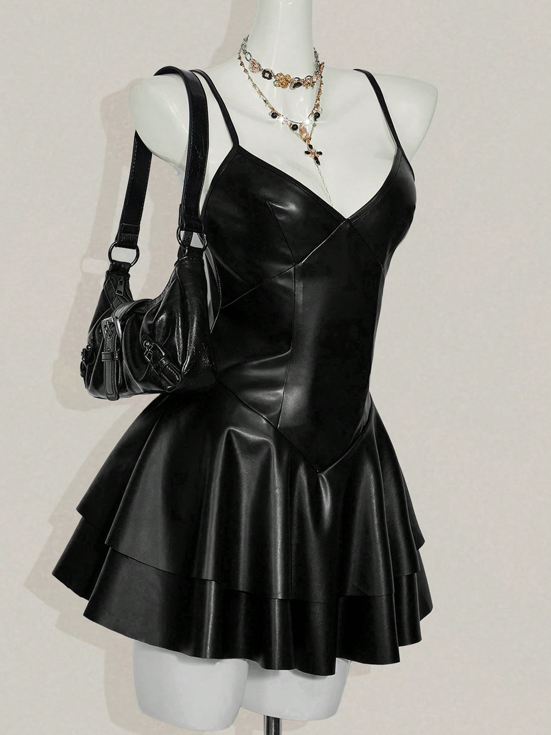 Women's Y2K PU leather mini dress with spaghetti straps, V-neckline, backless design, zipper closure, high waist, slim A-line fit, and layered tiered hem.