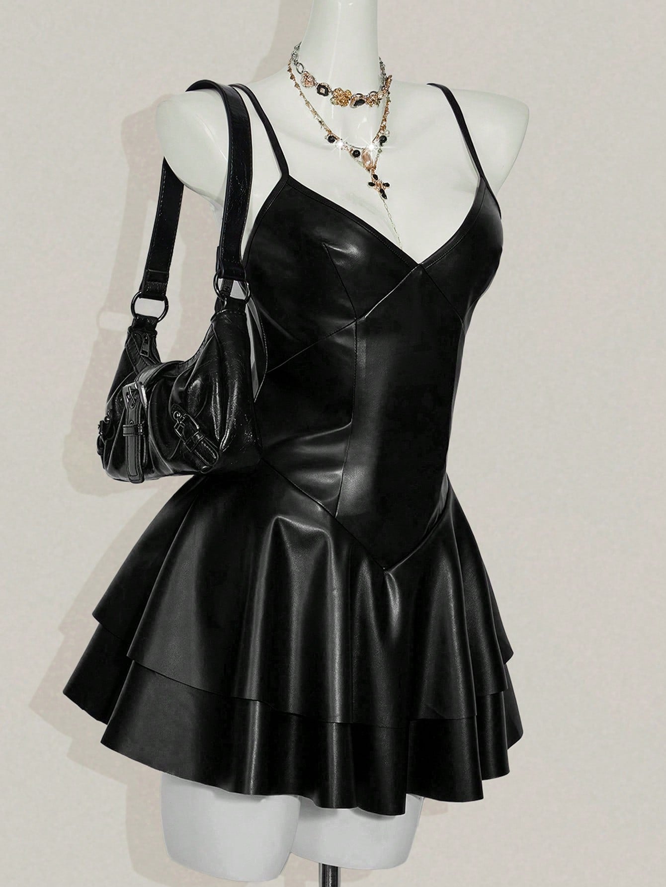 Women's Y2K PU leather mini dress with spaghetti straps, V-neckline, backless design, zipper closure, high waist, slim A-line fit, and layered tiered hem.