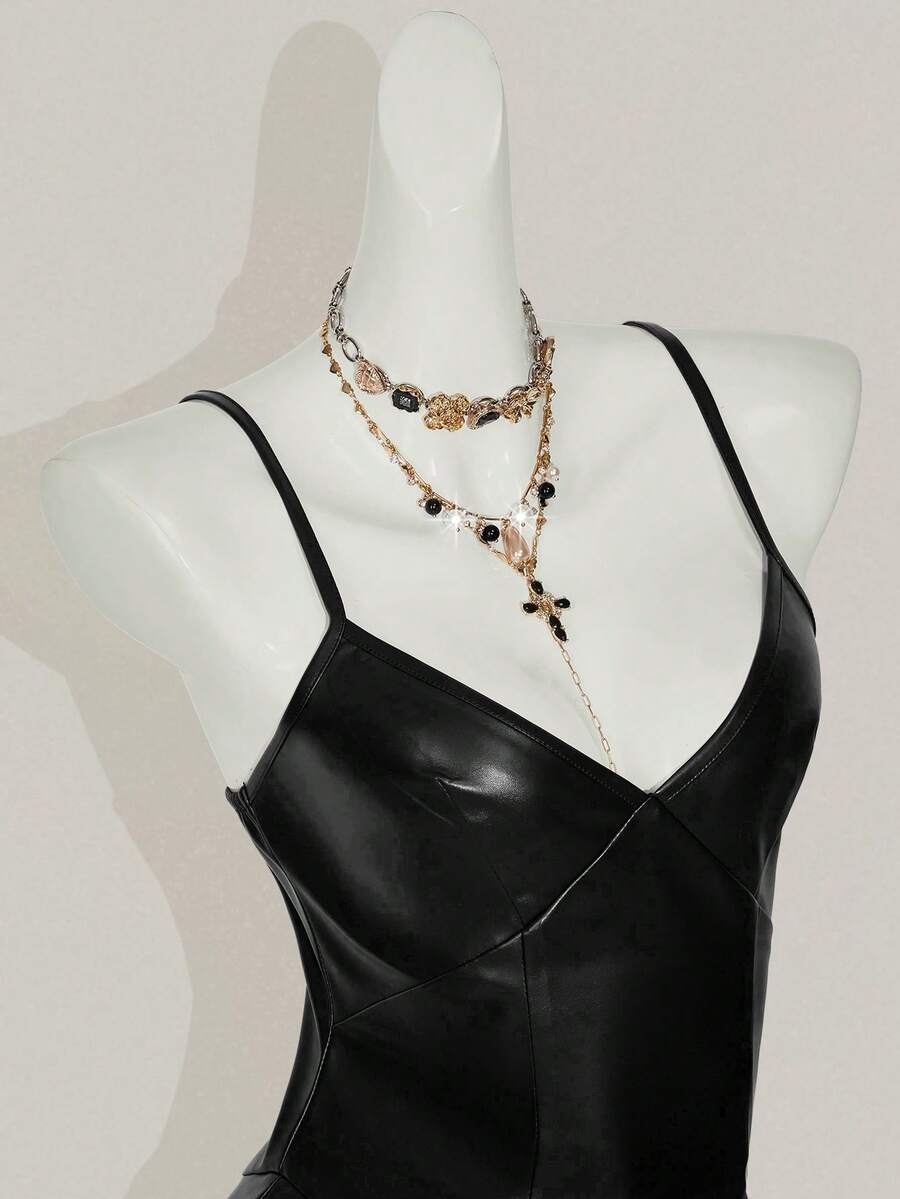 Women's Y2K PU leather mini dress with spaghetti straps, V-neckline, backless design, zipper closure, high waist, slim A-line fit, and layered tiered hem.