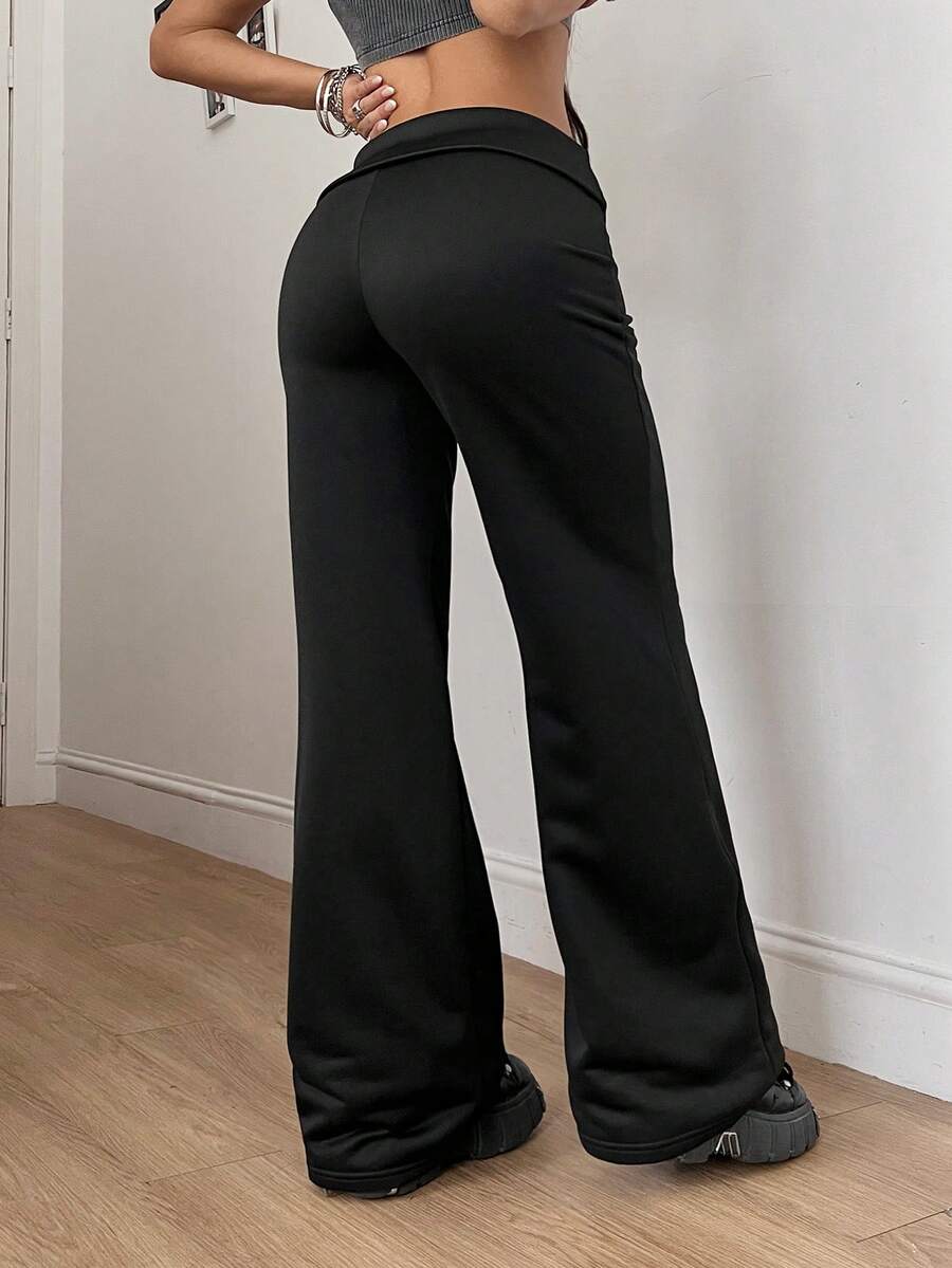 Women's black low waist wide leg flare sweatpants with rib-knit texture and contrast binding details.