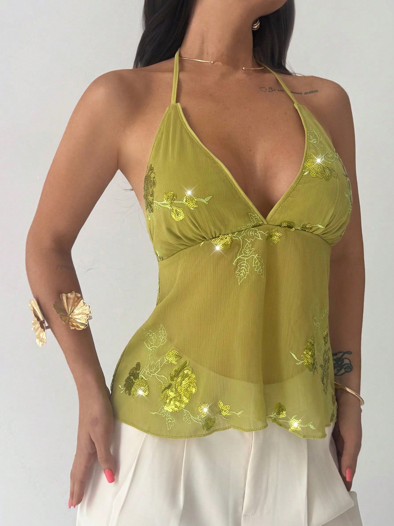 Firerie women's green crop cami top with beaded floral embroidery, spaghetti straps, lace-up back, and flared hem