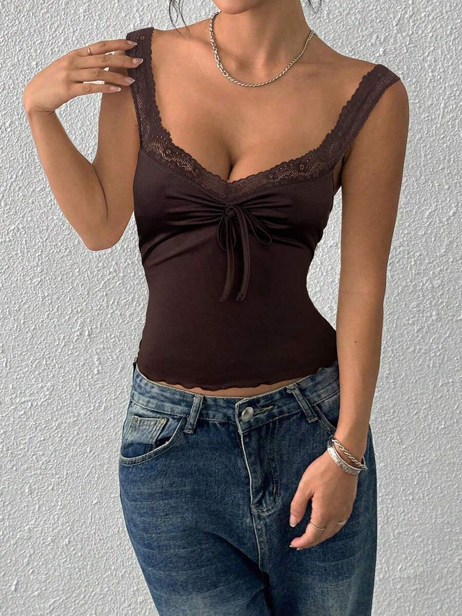 Women's slim fit casual camisole featuring wide shoulder straps, contrast lace trim, a front knot, and ruched details.