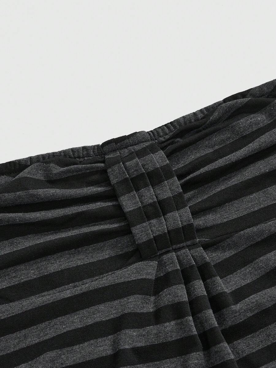 Women's striped strapless tube top featuring ruched detailing, flared hem, and stretchy knit fabric.