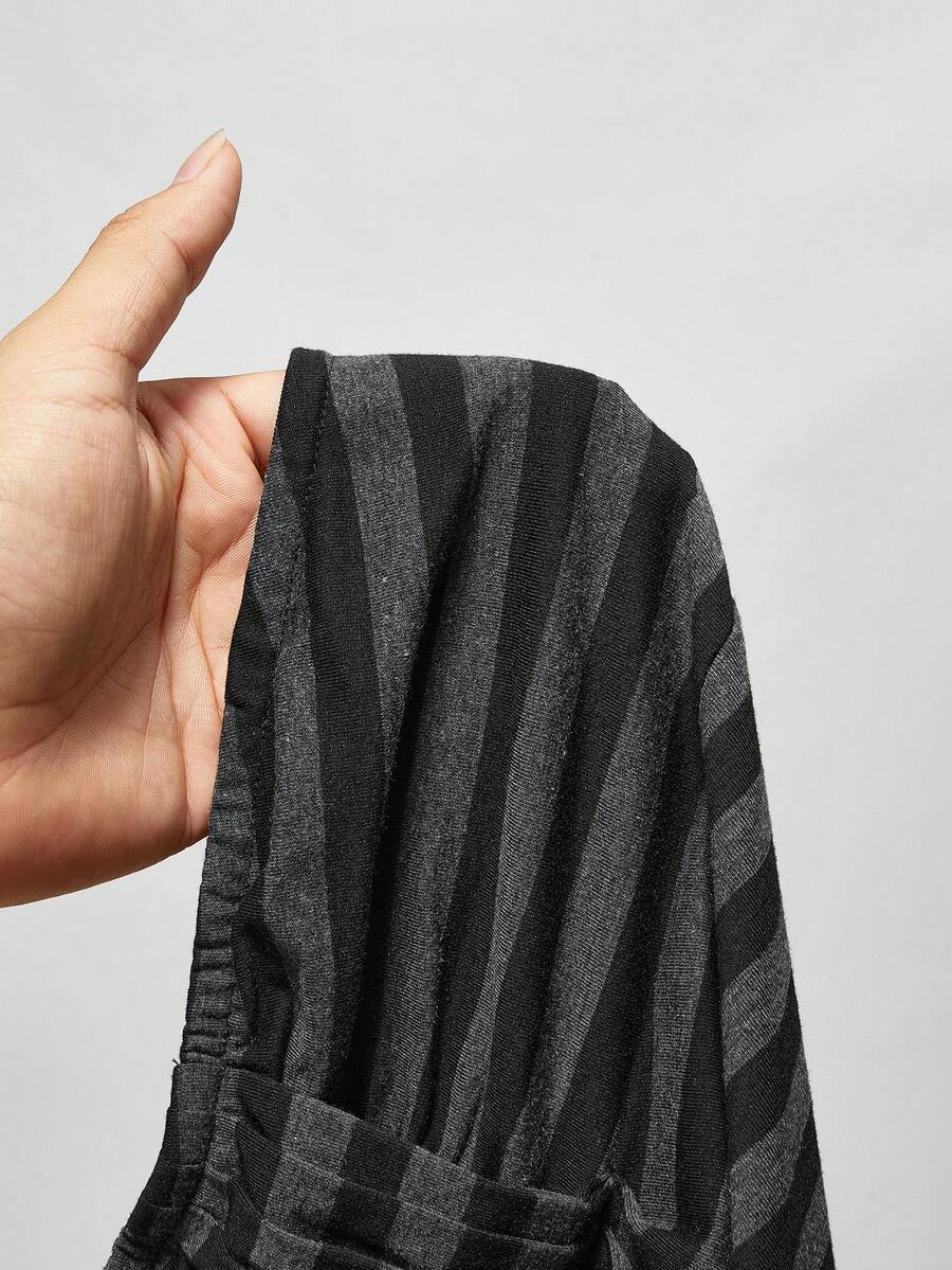 Women's striped strapless tube top featuring ruched detailing, flared hem, and stretchy knit fabric.