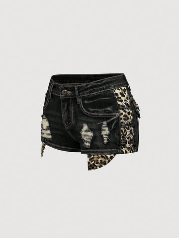 Women's ultra low waist vintage Y2K leopard print skinny mini shorts featuring ripped details, button, and zipper fly.