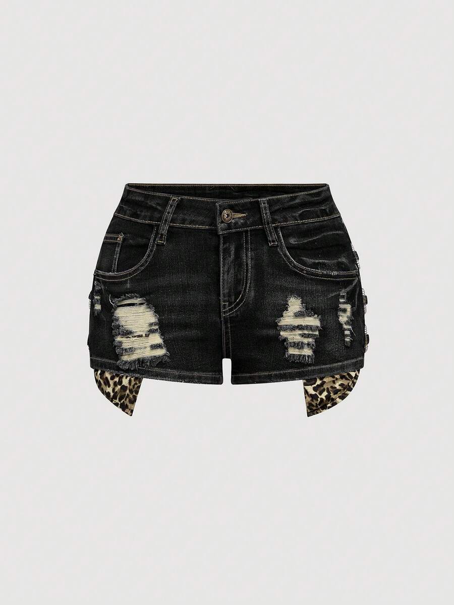 Women's ultra low waist vintage Y2K leopard print skinny mini shorts featuring ripped details, button, and zipper fly.