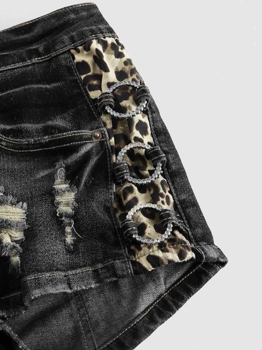 Women's ultra low waist vintage Y2K leopard print skinny mini shorts featuring ripped details, button, and zipper fly.
