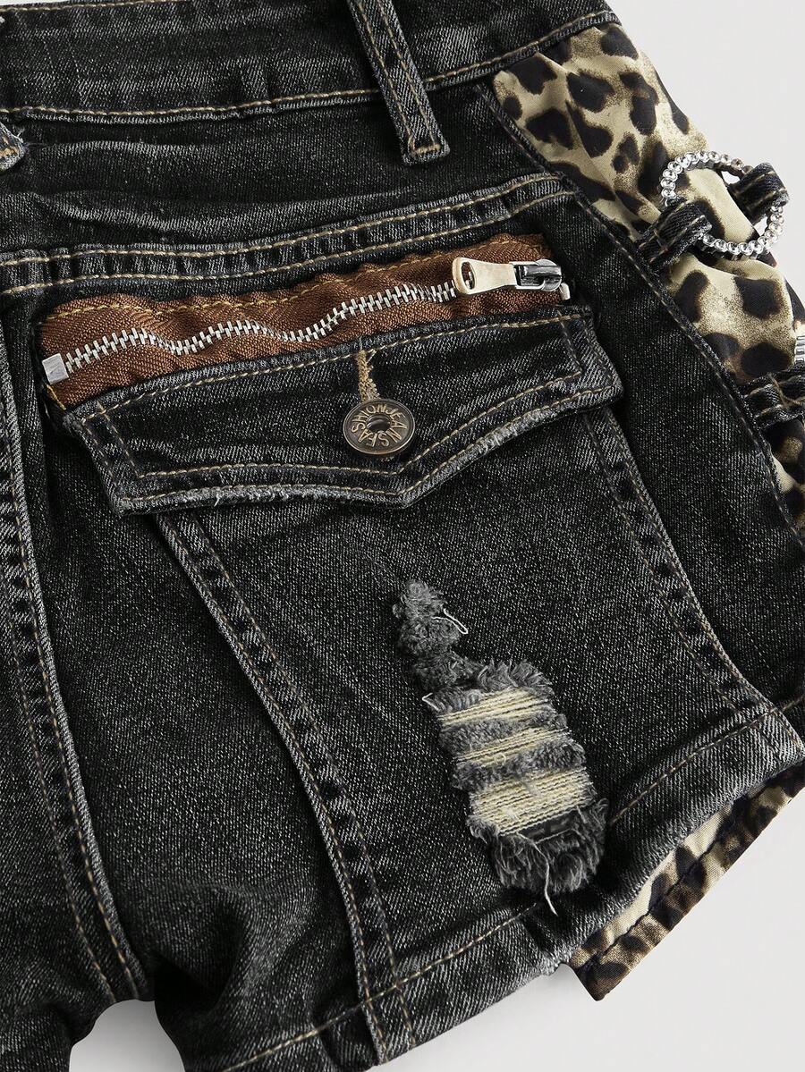 Women's ultra low waist vintage Y2K leopard print skinny mini shorts featuring ripped details, button, and zipper fly.