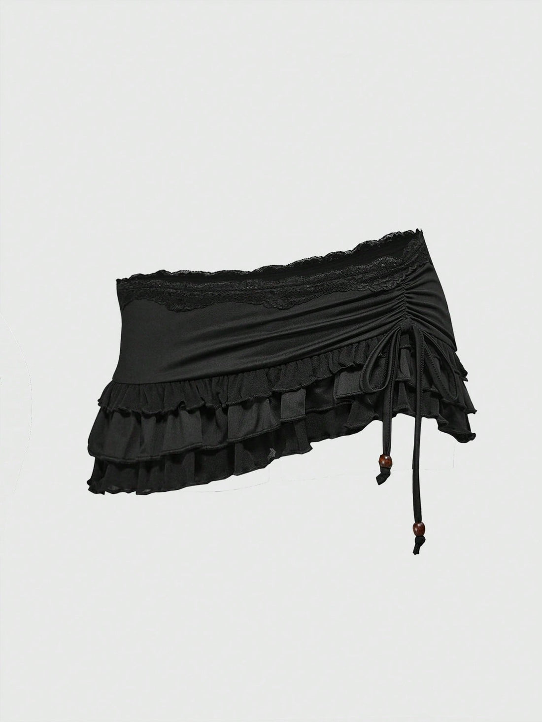 Women's black low-waist mini skirt with drawstring tie, ruched details, lace trim, layered ruffle hem, and asymmetric styling