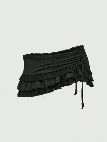 Women's black low-waist mini skirt with drawstring tie, ruched details, lace trim, layered ruffle hem, and asymmetric styling