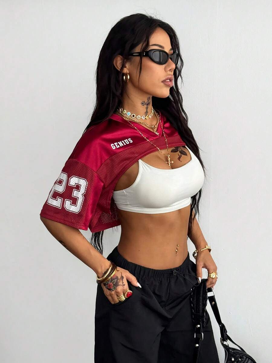 Front view of a women's black and white striped short sleeve crop top with a round neckline and semi-sheer knit finish.