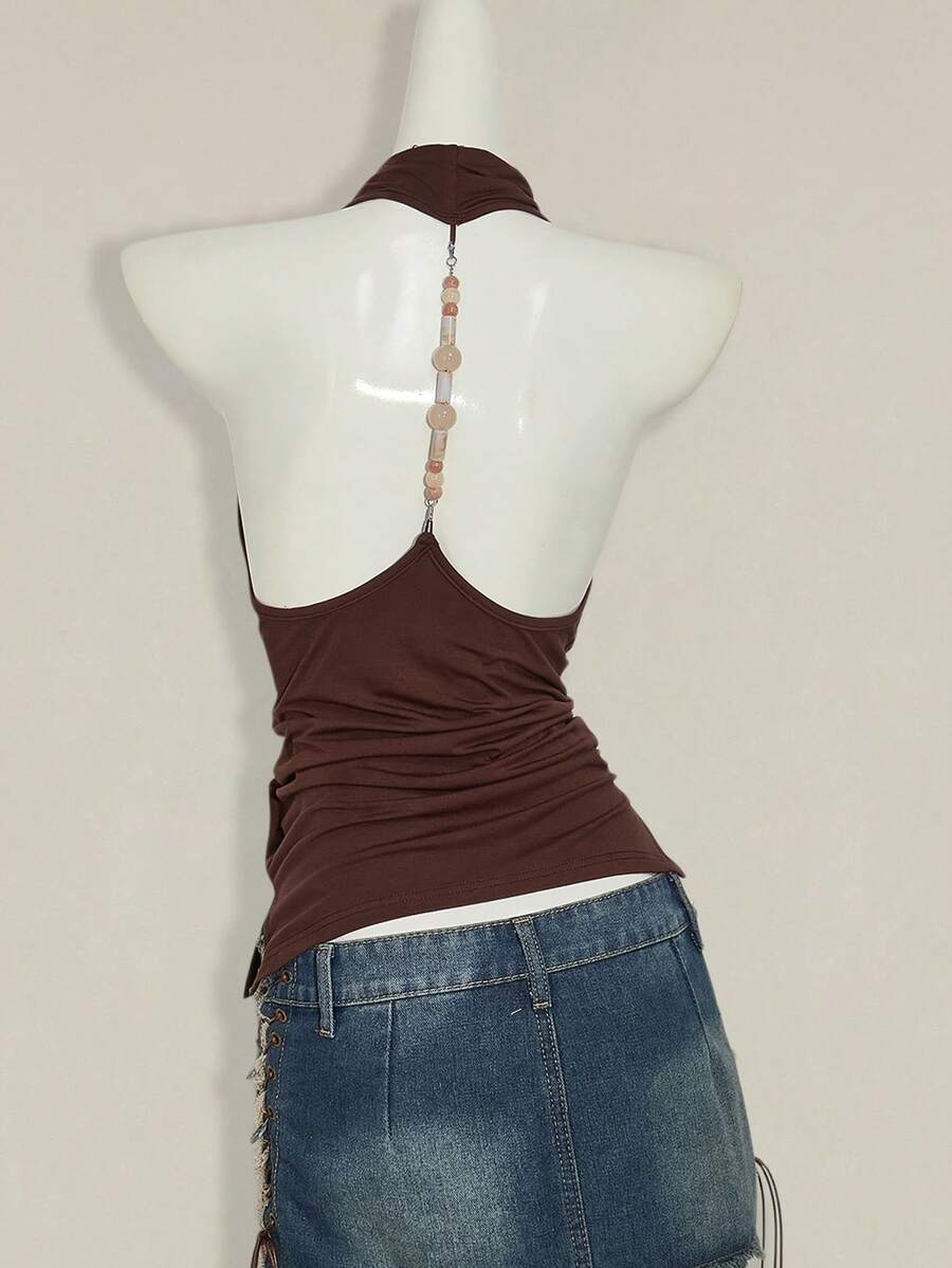 Women's coffee brown backless halter camisole top with draped neckline, ruched details, slim fit, and plain design.