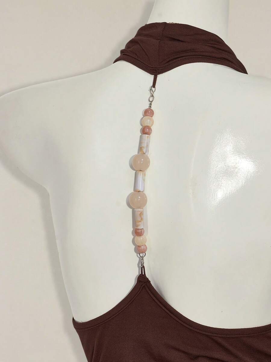 Women's coffee brown backless halter camisole top with draped neckline, ruched details, slim fit, and plain design.