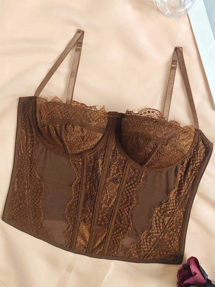 Women's lace bustier corset cami top with spaghetti straps, arm sleeves, asymmetrical contrast lace detail, and buckle accent
