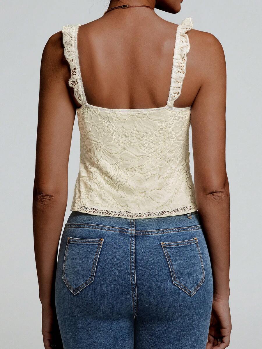 Sleeveless cami tank top featuring contrast lace patchwork design, ruffle spaghetti straps, and bow decor.