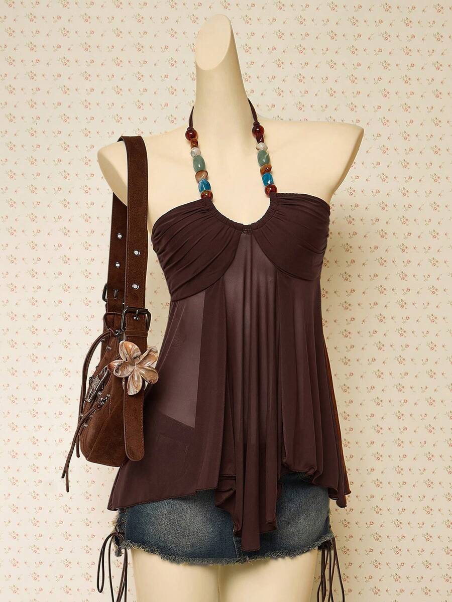 Women's boho halter mesh tank top with asymmetrical hem, semi-sheer finish, lined body, slim fit, and cold shoulder styling.