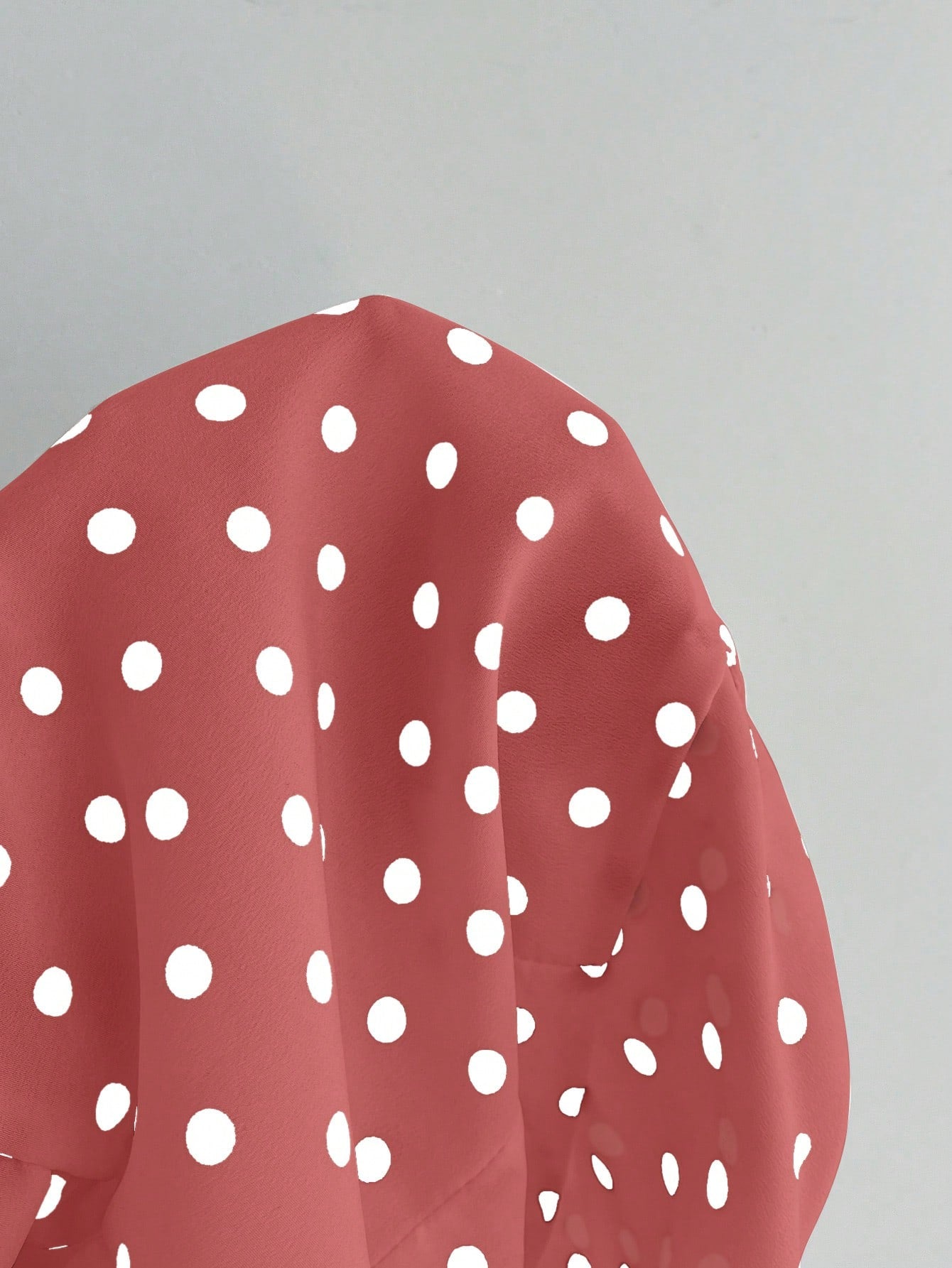 Women's polka dot halter camisole with bow bust detail, ruched and shirred design, slim crop fit, and flared ruffle hem.