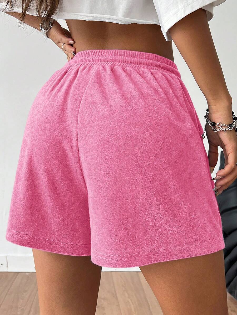 Women's casual drawstring track shorts featuring front pockets and embroidered details