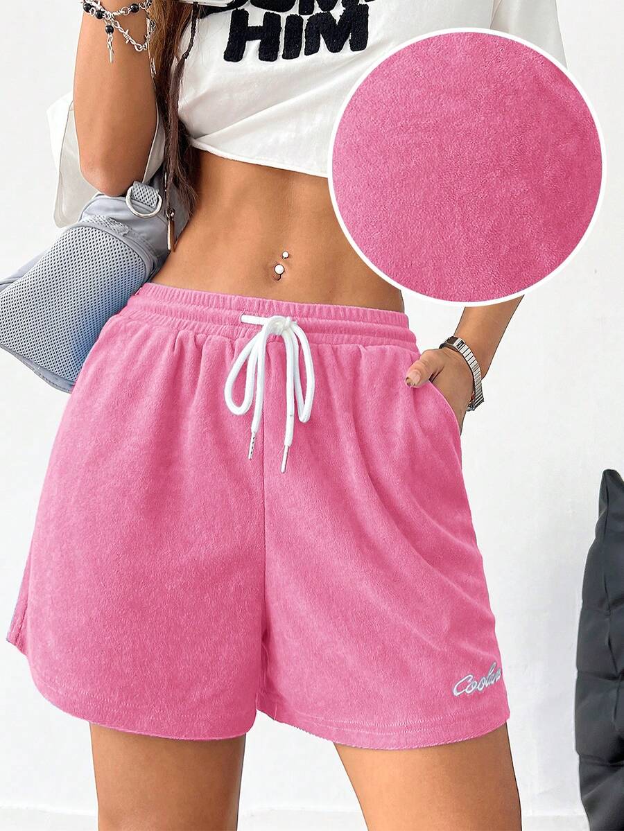 Women's casual drawstring track shorts featuring front pockets and embroidered details