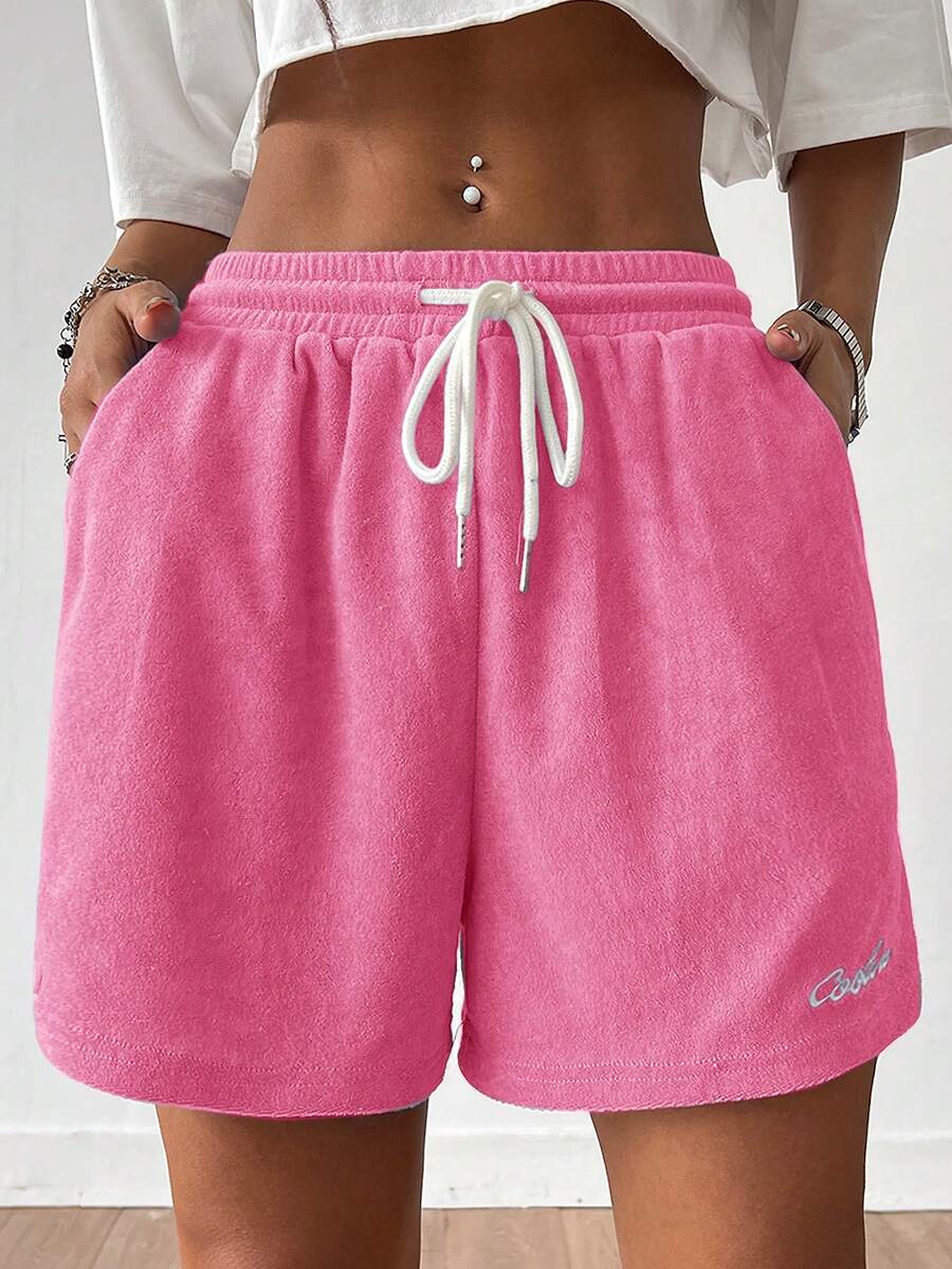 Women's casual drawstring track shorts featuring front pockets and embroidered details