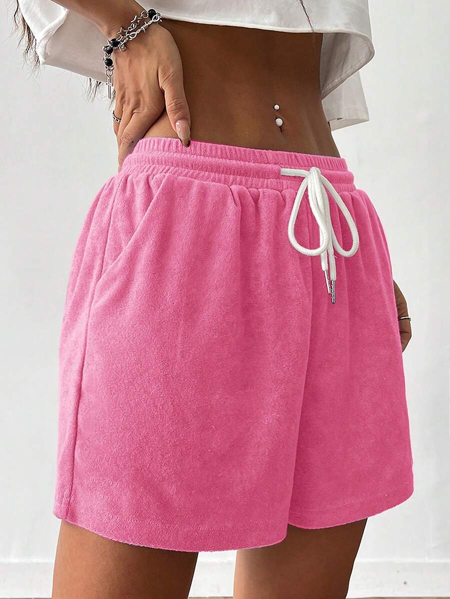 Women's casual drawstring track shorts featuring front pockets and embroidered details