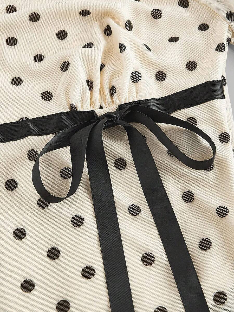 Women's polka dot mesh T-shirt with long flare sleeves, square neckline, bow detail, and asymmetric ruffle hem.