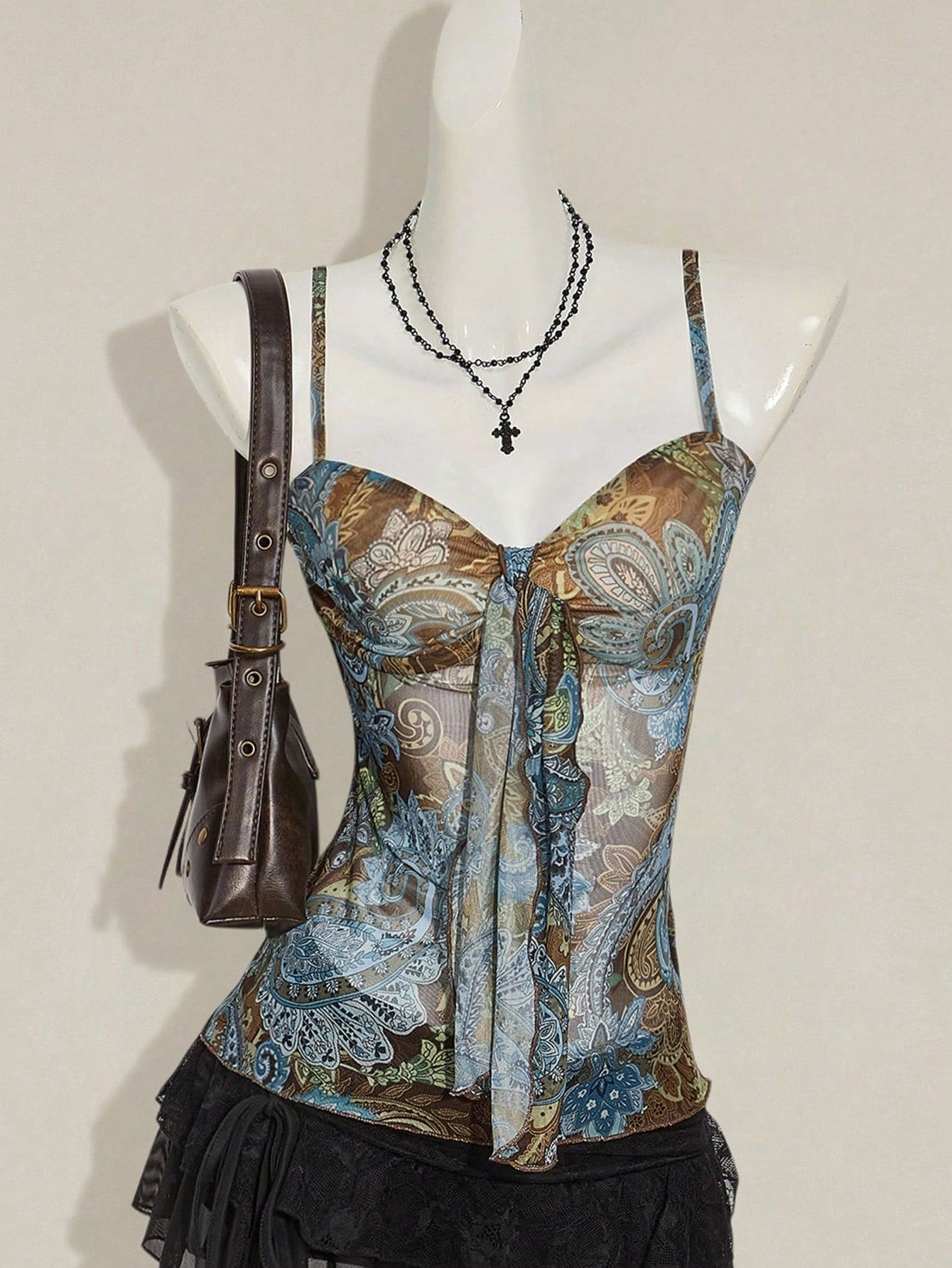 Women's green paisley print Y2K cami top with spaghetti straps, pleated styling, lace-up knot detail, and asymmetrical boho design.