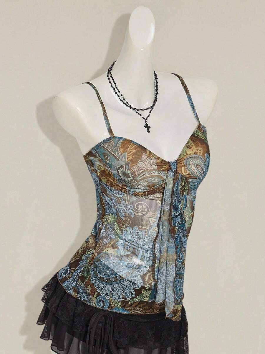 Women's green paisley print Y2K cami top with spaghetti straps, pleated styling, lace-up knot detail, and asymmetrical boho design.
