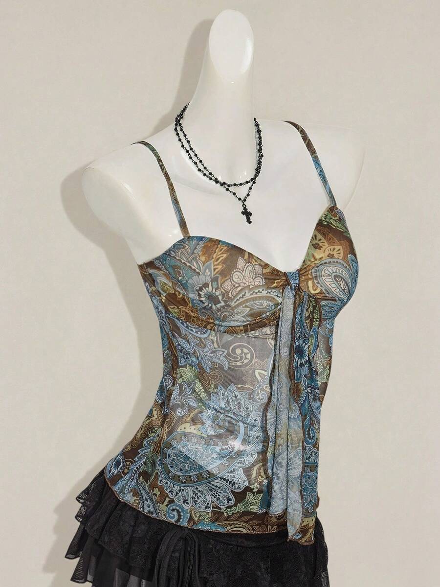 Women's green paisley print Y2K cami top with spaghetti straps, pleated styling, lace-up knot detail, and asymmetrical boho design.