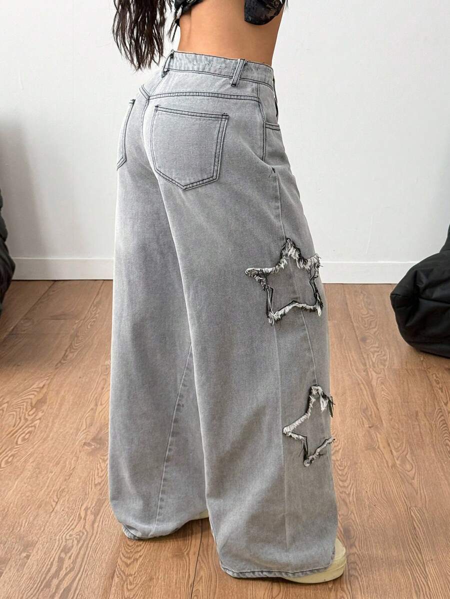 Front view of women's loose wide leg denim jeans featuring a mid waist, classic front pockets, and a zipper fly closure.