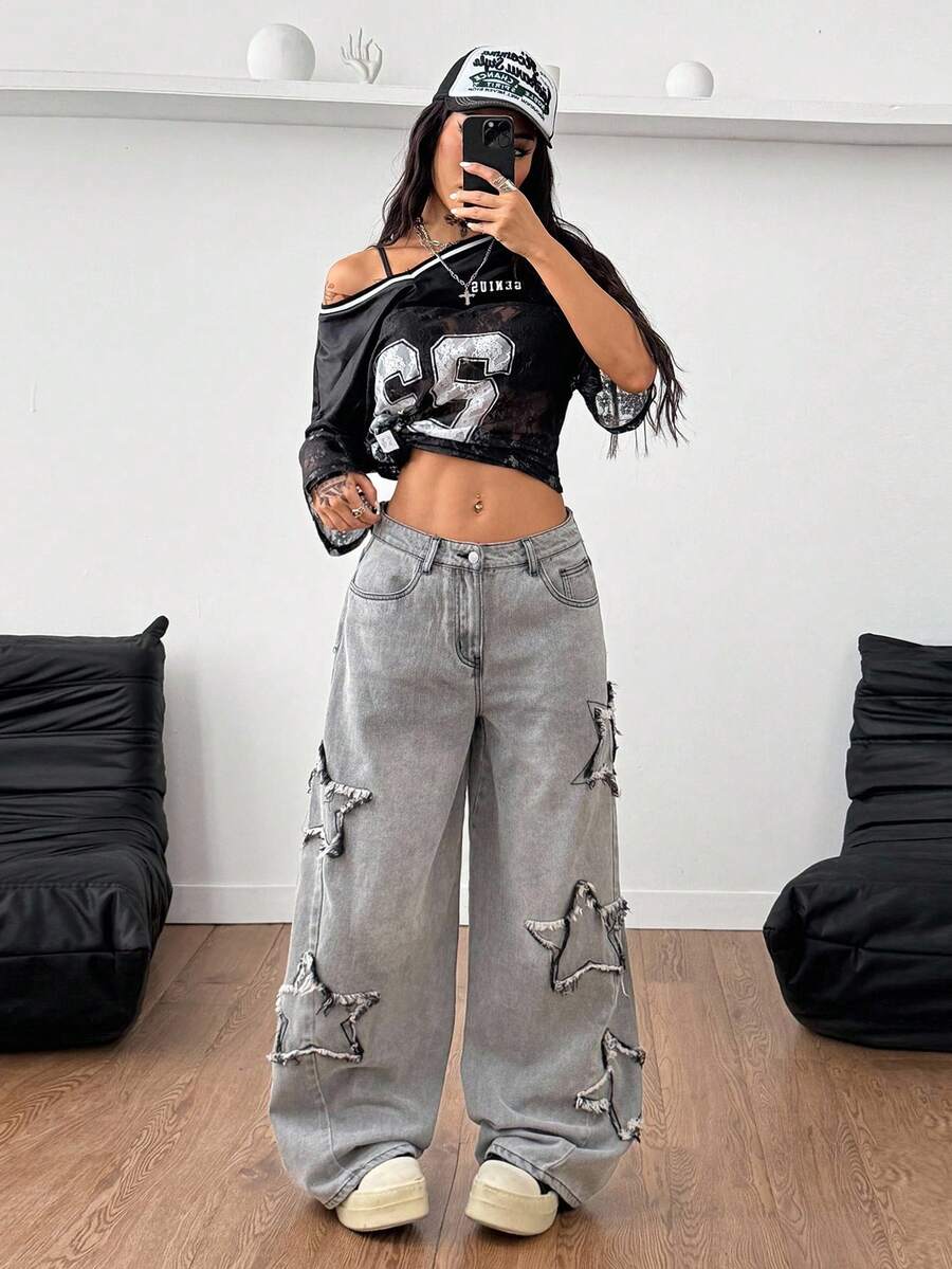 Front view of women's loose wide leg denim jeans featuring a mid waist, classic front pockets, and a zipper fly closure.