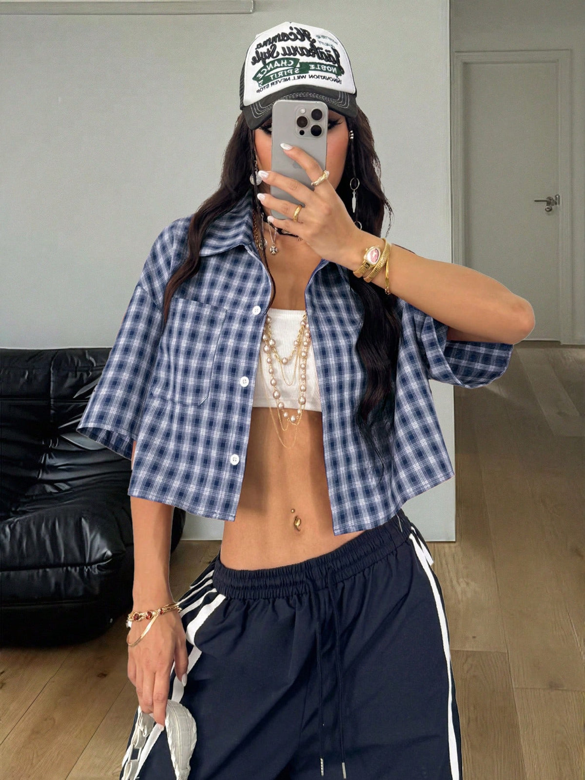 Women's plaid crop shirt with button front, chest pocket, short sleeves, and loose casual fit.