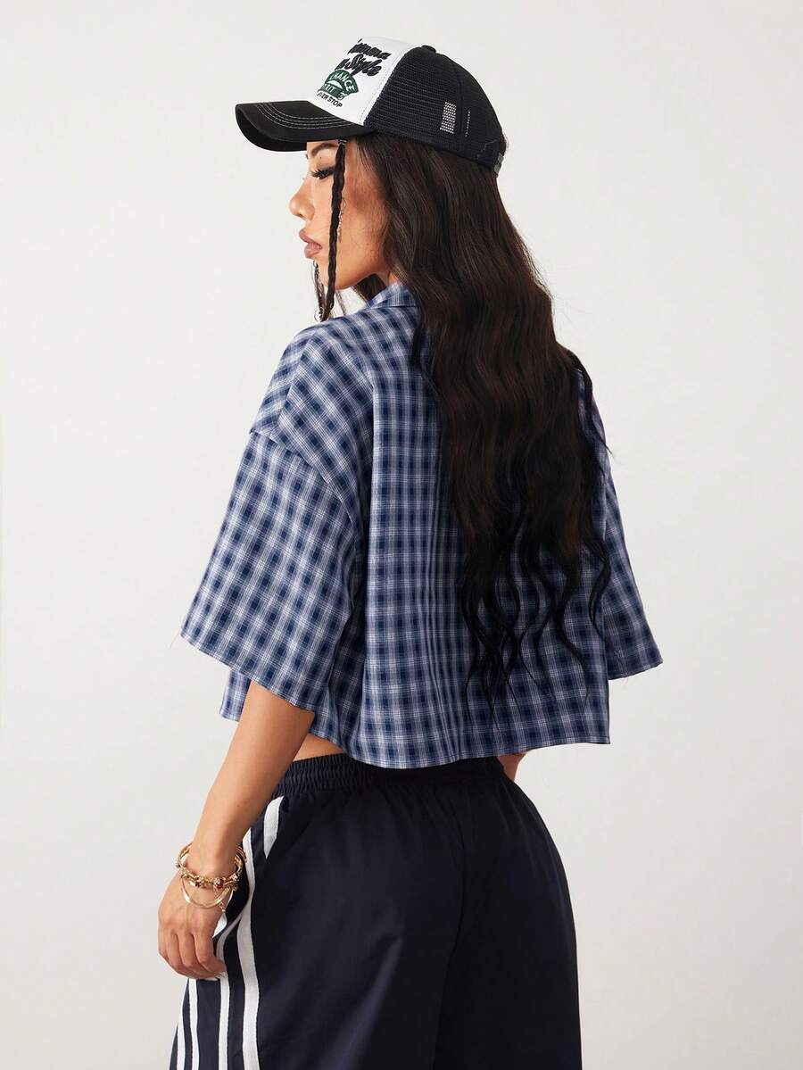 Women's plaid crop shirt with button front, chest pocket, short sleeves, and loose casual fit.