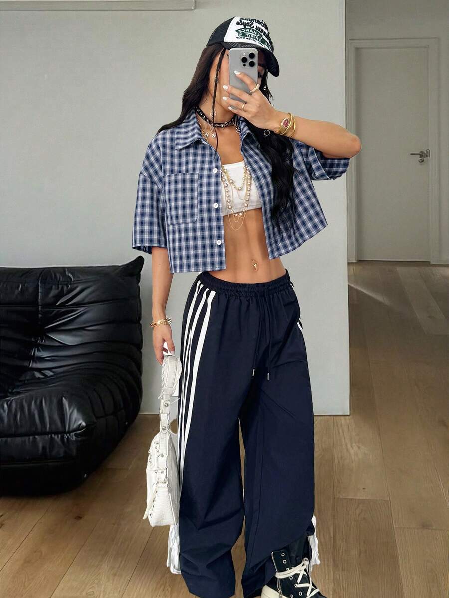 Women's plaid crop shirt with button front, chest pocket, short sleeves, and loose casual fit.