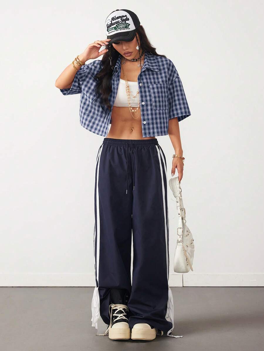 Women's plaid crop shirt with button front, chest pocket, short sleeves, and loose casual fit.
