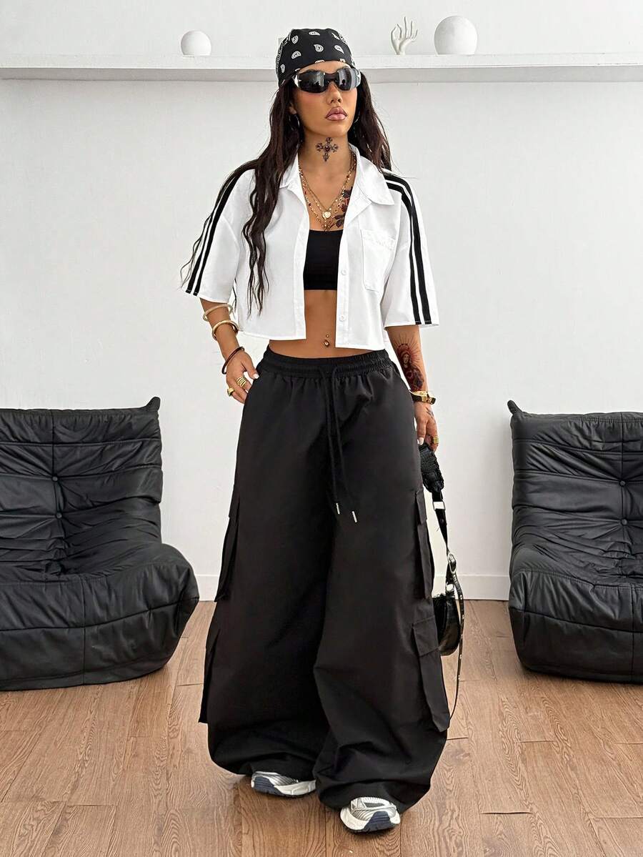 Women's plaid crop shirt with button front, chest pocket, short sleeves, and loose casual fit.