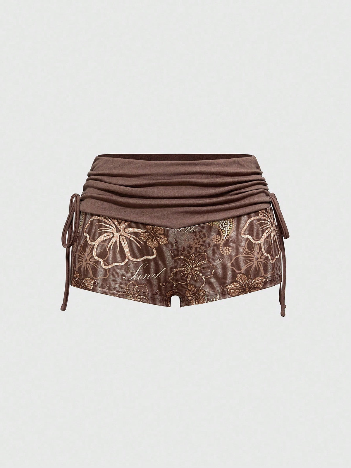 Women's low waist mini track shorts with elastic waistband, drawstring knot, ruched details, and plant pattern in a Y2K boho style